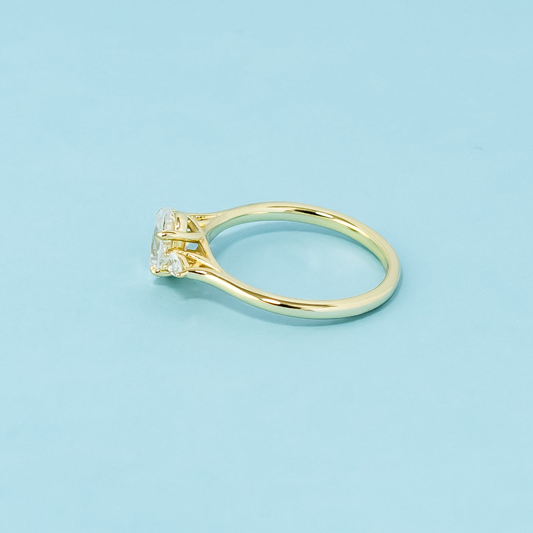 This 9ct yellow gold ring features a classic trilogy design with three beautifully cut oval moissanites.