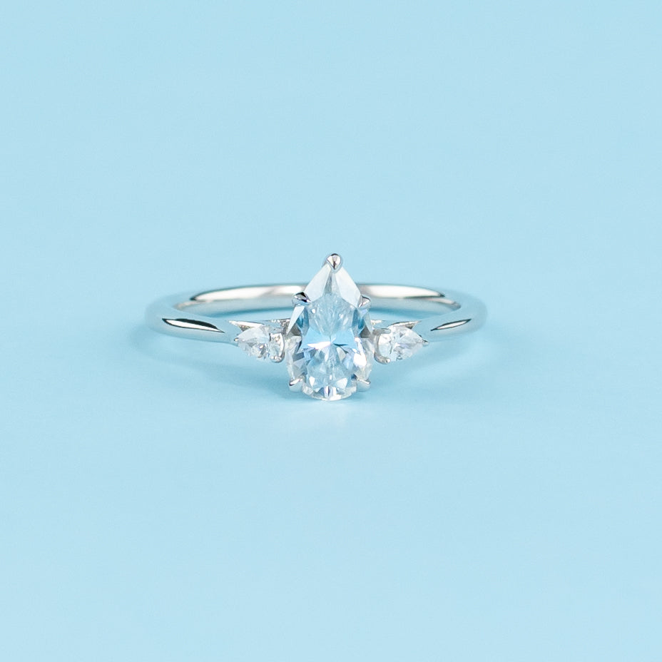 Elegant 9ct white gold engagement ring featuring a trilogy design with three sparkling pear-shaped moissanites.
