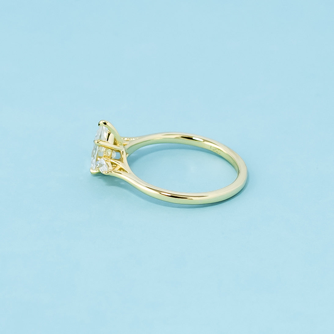 An elegant 9ct yellow gold trilogy ring with three brilliant pear-shaped moissanites.