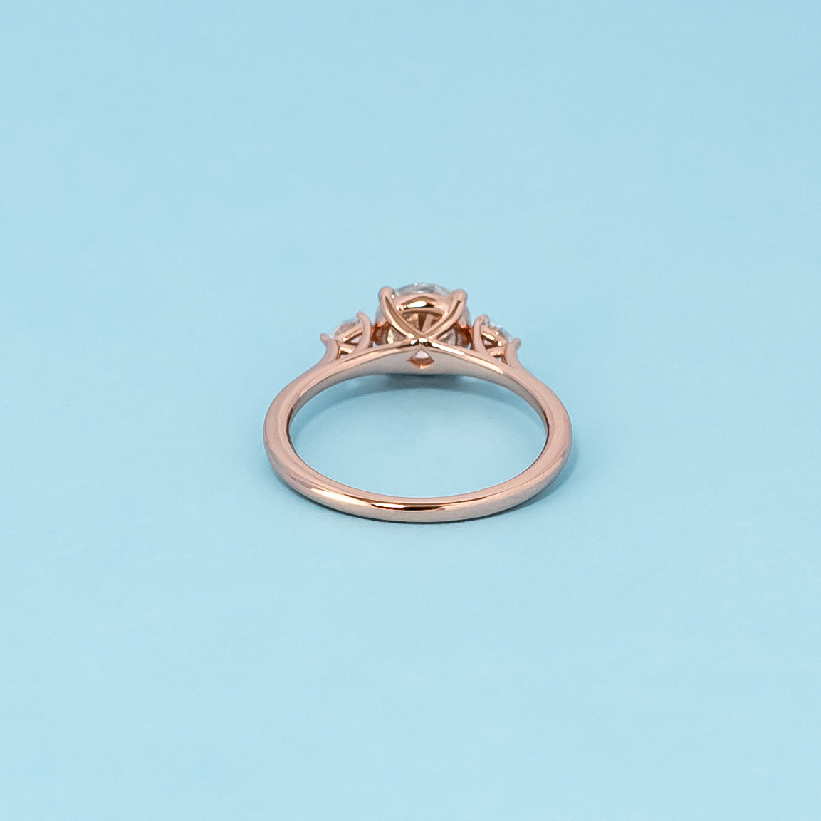 Luxurious 9ct rose gold engagement ring set featuring three beautiful round brilliant moissanites, representing enduring love.