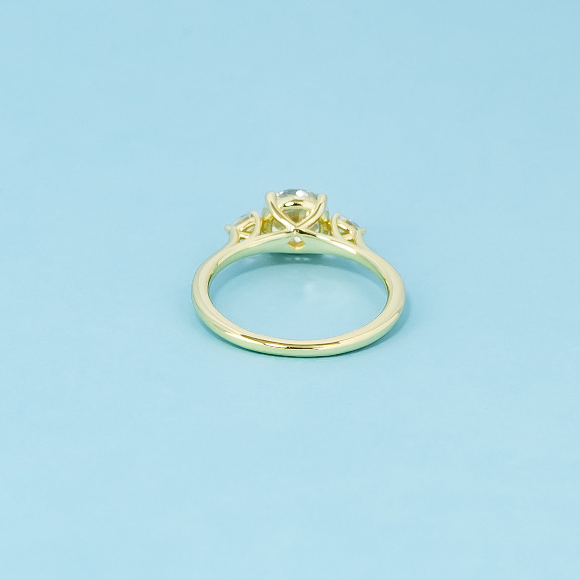 An elegant 9ct yellow gold engagement ring with three brilliant round brilliant moissanites, representing a lifetime of commitment.