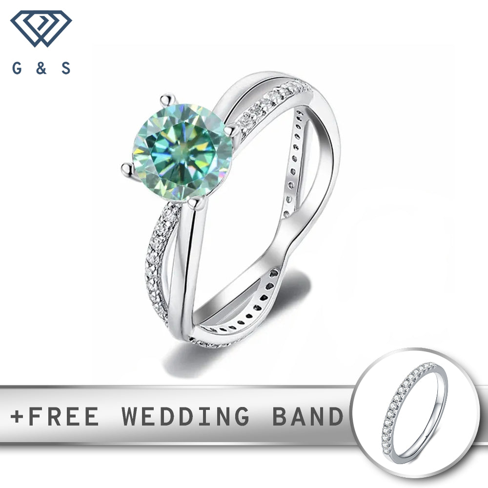 A delicate sterling silver band forms an infinity symbol, cradling a vibrant 1.00ct green moissanite at its center.