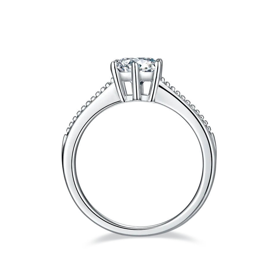 A timeless engagement ring featuring a dazzling 1.00ct moissanite in a traditional solitaire setting with intricate milgrain work on the band.