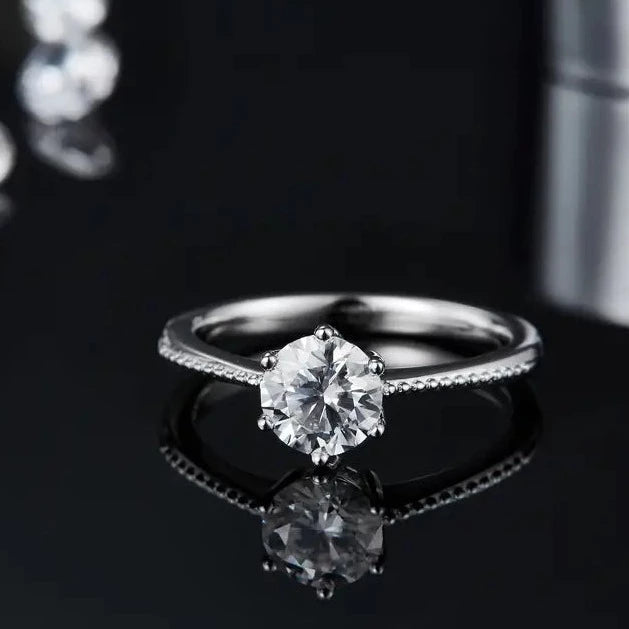 A beautifully crafted sterling silver engagement ring featuring a prominent 1.00ct moissanite in a classic solitaire design with delicate milgrain edging.