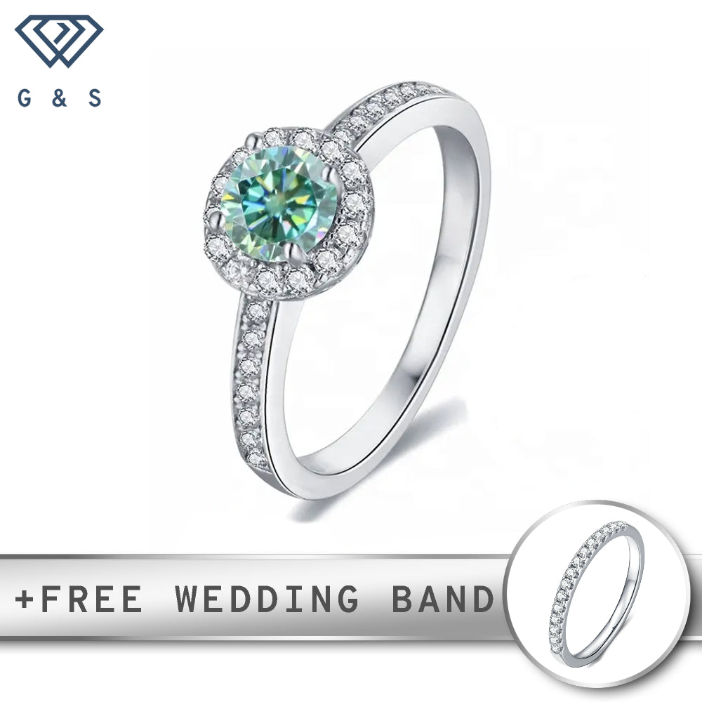 A sterling silver engagement ring featuring a vibrant 0.50ct green moissanite center stone surrounded by a sparkling pave halo.