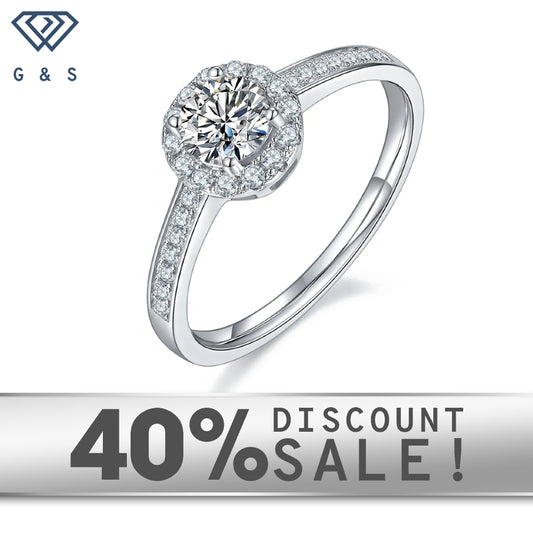 A 0.50ct moissanite sparkles within a pave halo setting on a 9ct white gold band.