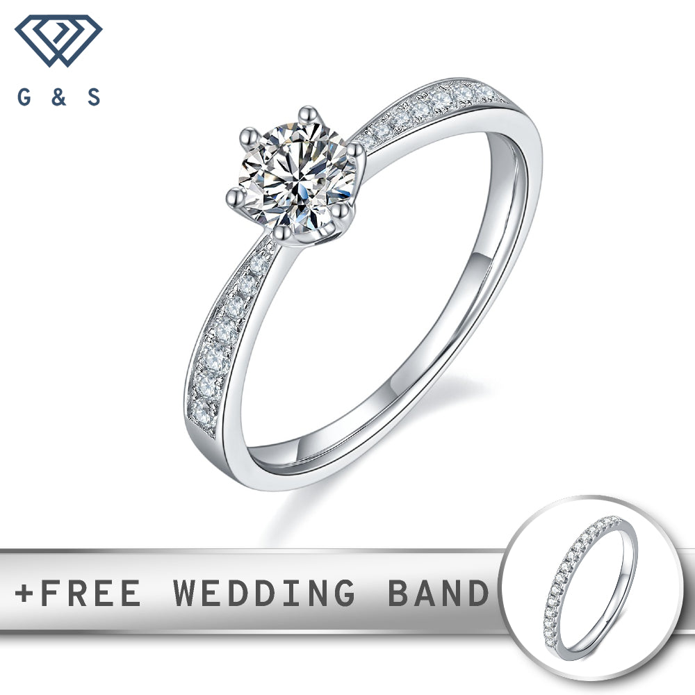Classic Tiffany-style setting with six prongs holding a 0.50ct moissanite, accented with pave-set stones on the band, all in sterling silver.