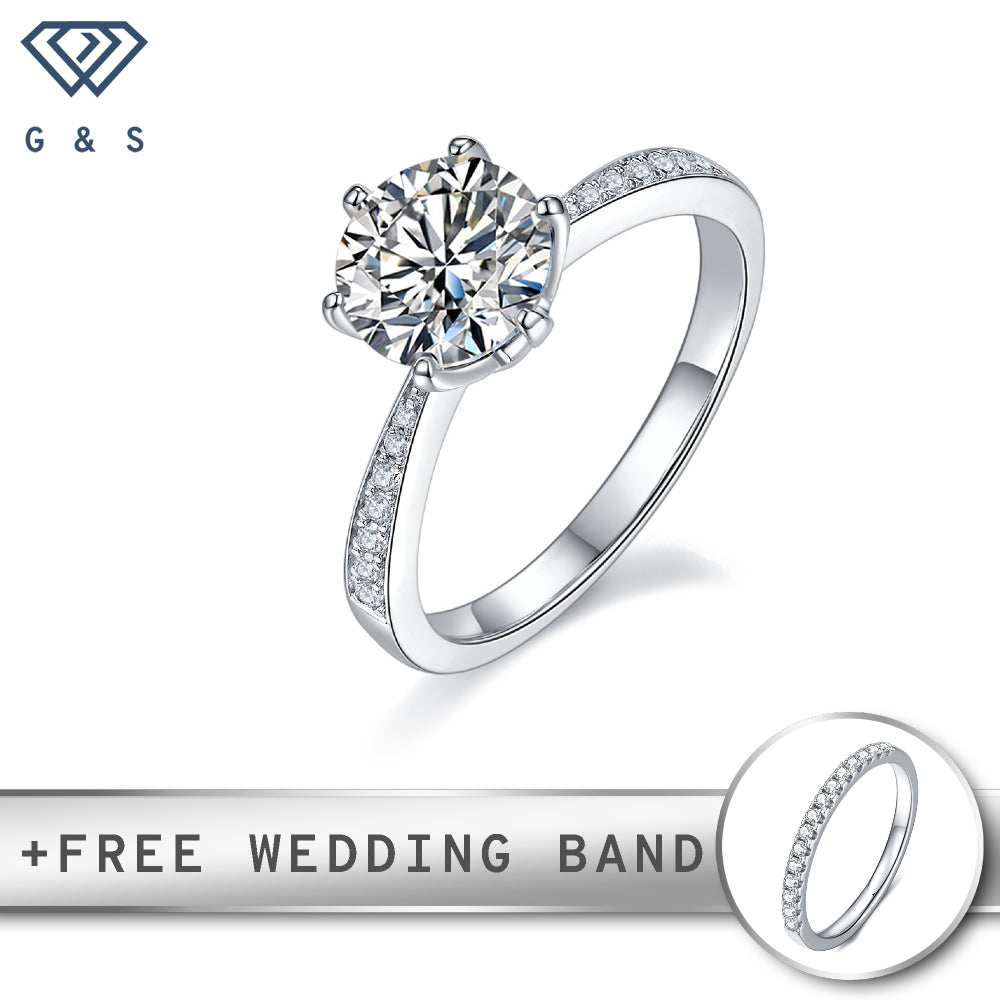 A sterling silver engagement ring featuring a 1.50ct moissanite in a classic Tiffany 6-claw setting, with a pave-set band for added sparkle.