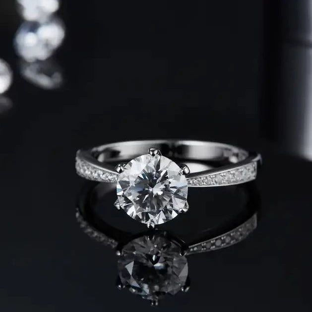 A sterling silver engagement ring combining the timeless Tiffany 6-claw setting with a modern pave-set band, featuring a stunning 1.50ct moissanite.
