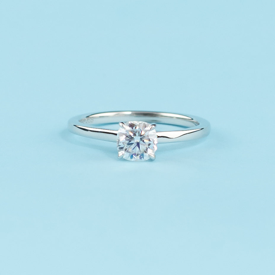 Elegant 9ct white gold engagement ring featuring a cushion cut moissanite with a hidden halo for added sparkle.