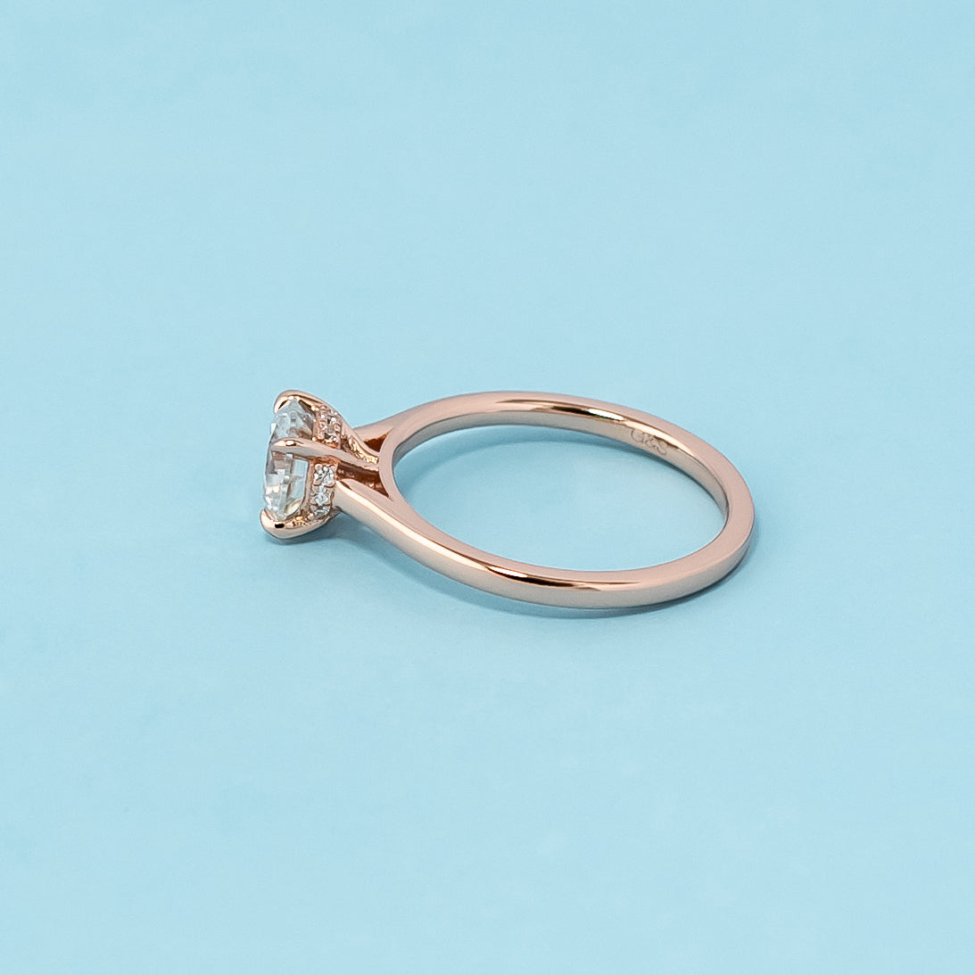 Stunning rose gold engagement ring featuring a sparkling round brilliant moissanite and a secret sparkle hidden halo design.