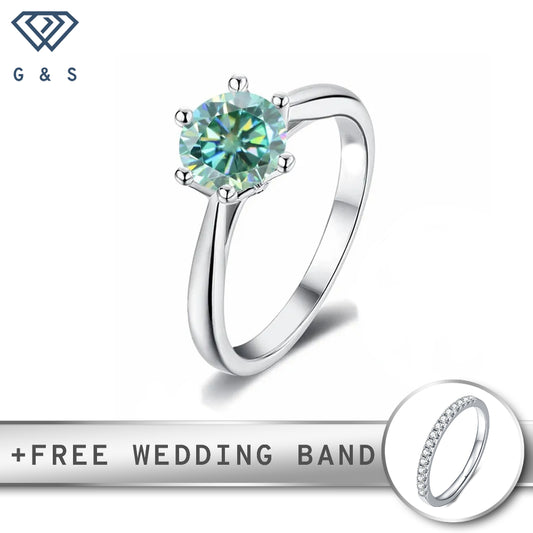 A 1.00ct green moissanite shines in a six-prong floral basket setting on a polished sterling silver band.