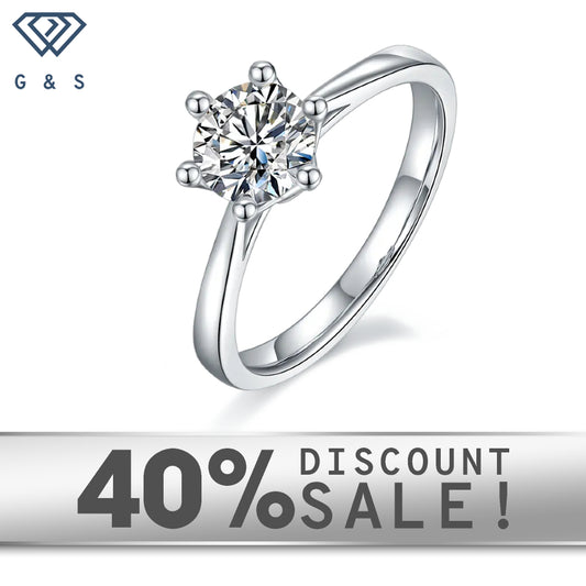 A 1.00ct moissanite sparkles in a timeless 6-claw setting with a delicate floral basket design, crafted in 9ct white gold.