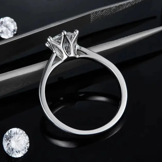 A timeless engagement ring in sterling silver, featuring a 1.00ct moissanite held by six claws within a beautifully crafted floral basket, adding a delicate touch.