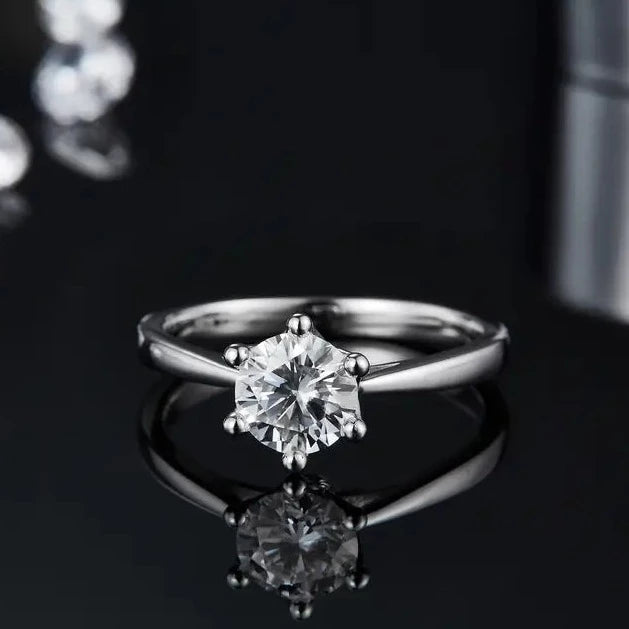 Elegant 1.00ct Moissanite Ring, held in a detailed floral basket design with 6 claws, on a slim sterling silver band. The light reflects wonderfully off the moissanite.