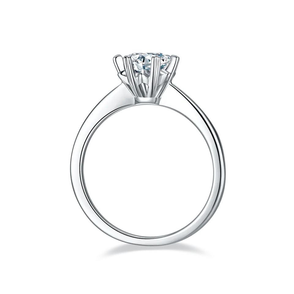 This ring showcases a dazzling 1.00ct moissanite solitaire in a charming sterling silver setting, featuring six heart-shaped claws.