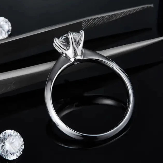 A delicate sterling silver engagement ring with a 1.00ct moissanite, designed with a traditional 6-claw setting for maximum brilliance.