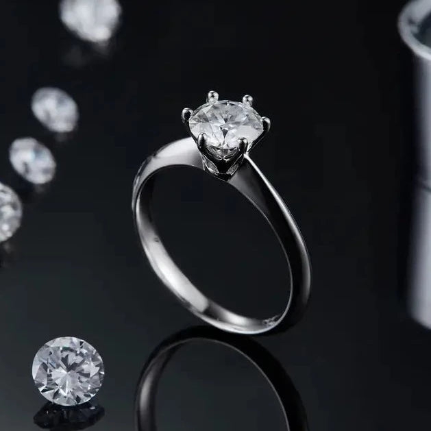A polished sterling silver engagement ring with a 1.00ct moissanite, set in a classic 6-claw Tiffany style.
