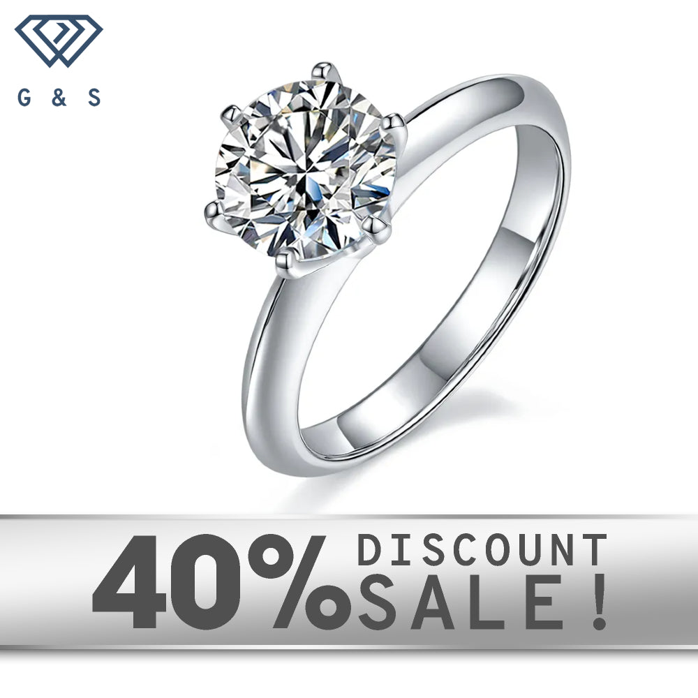 A 2.00ct moissanite sparkles in a timeless 6-claw Tiffany setting on a 9ct white gold band.