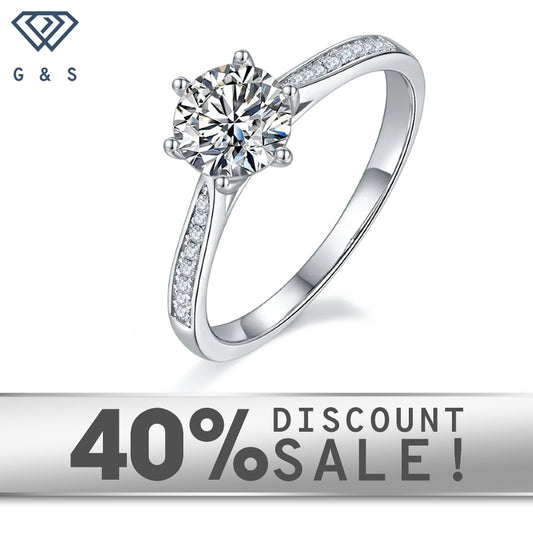 A 1.00ct moissanite center stone is highlighted by a delicate tapered pave setting on a 9ct white gold band.
