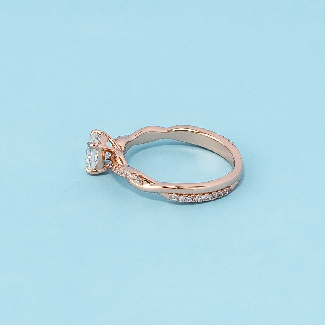 Stunning rose gold engagement ring featuring a sparkling cushion cut moissanite in a classic infinity design.