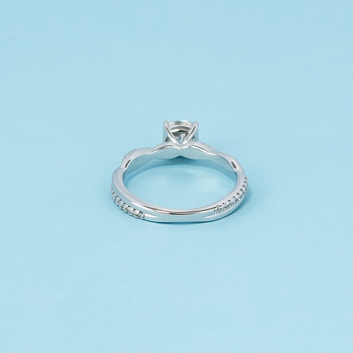 Infinity Cushion Cut Moissanite Engagement Ring in 9ct White Gold: A sophisticated engagement ring combining the brilliance of a cushion-cut moissanite with the symbolic design of an infinity band, crafted in 9ct white gold.