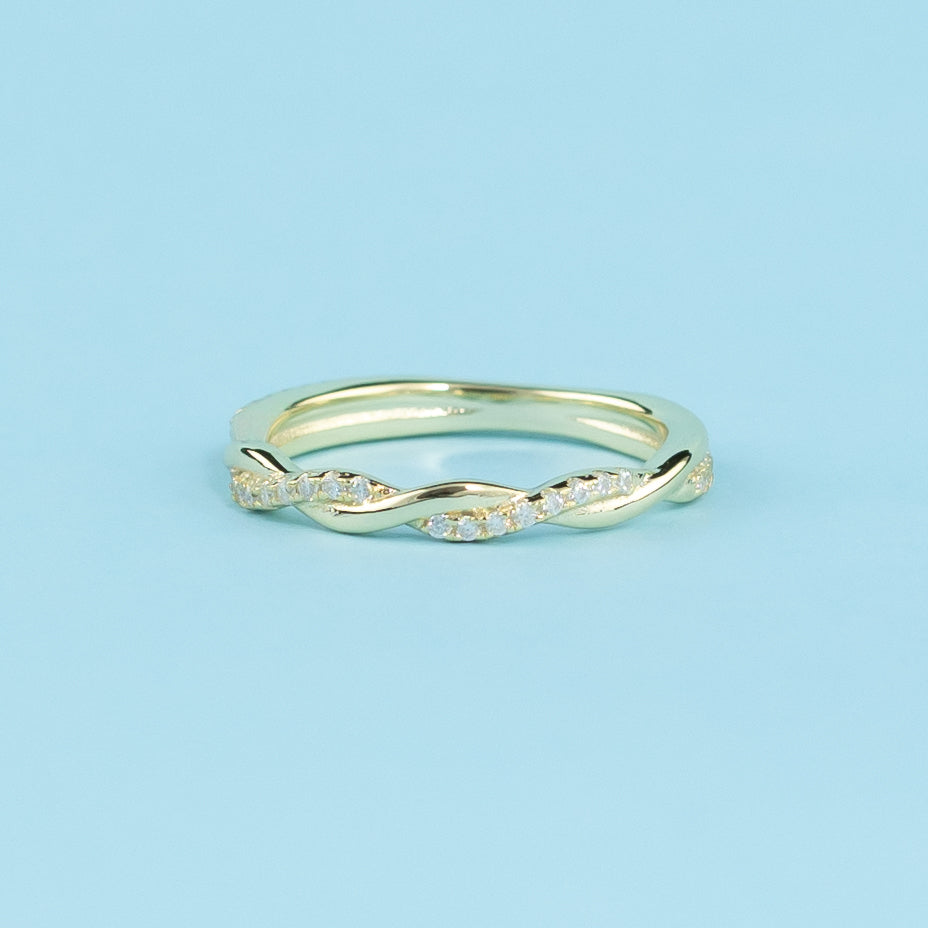 A symbol of everlasting commitment, these wedding bands showcase a delicate infinity pattern adorned with brilliant moissanites, crafted in polished 9ct yellow gold.