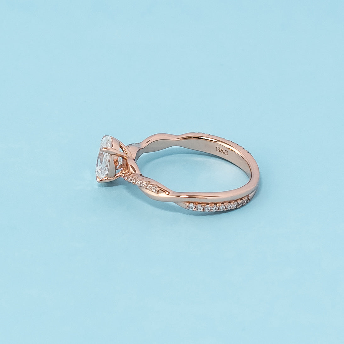 Stunning rose gold engagement ring featuring a sparkling oval cut moissanite in a classic infinity design.