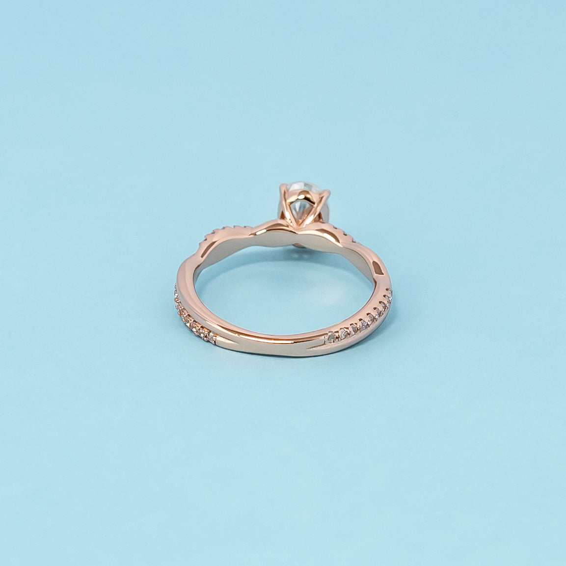 Luxurious 9ct rose gold engagement ring showcasing a beautiful oval cut moissanite in a timeless infinity setting.
