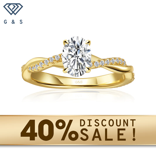  A 9ct yellow gold engagement ring featuring a sparkling oval cut moissanite and a flowing infinity design.