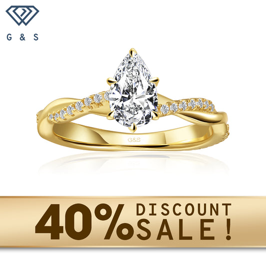 A 9ct yellow gold engagement ring featuring a pear-shaped moissanite and a flowing infinity design symbolizing eternal love.