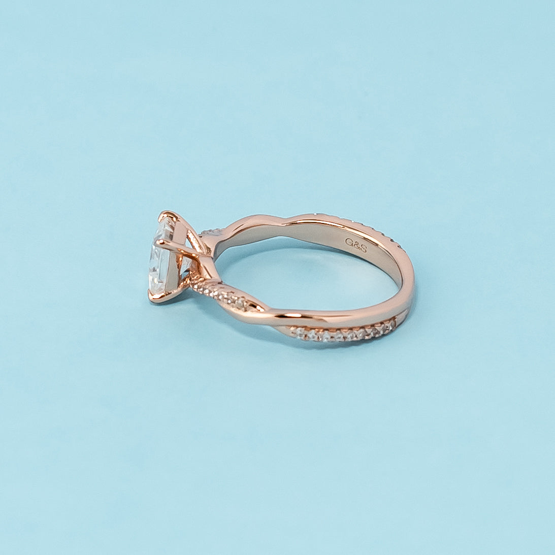 Stunning rose gold engagement ring featuring a sparkling princess cut moissanite in a classic infinity design.