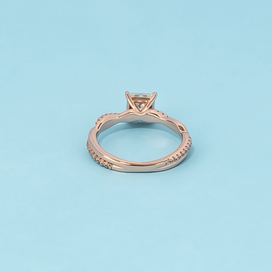 Luxurious 9ct rose gold engagement ring showcasing a beautiful princess cut moissanite in a timeless infinity setting.