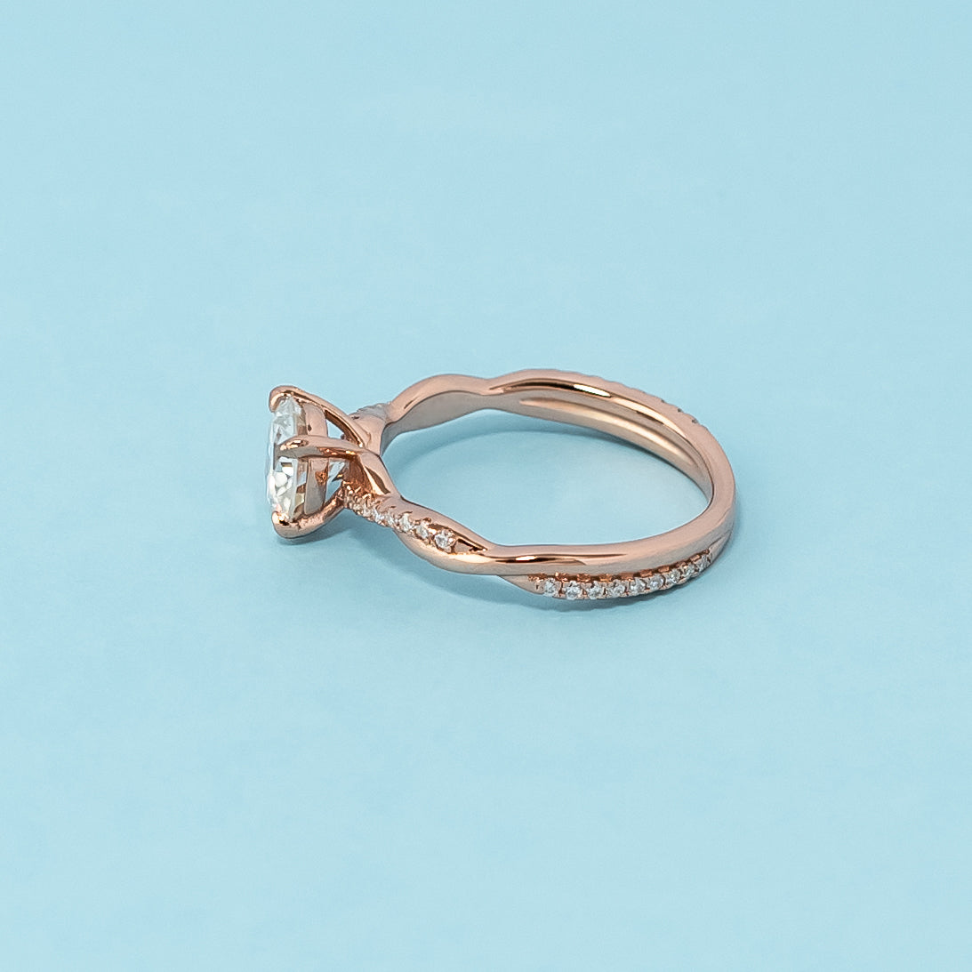 Stunning rose gold engagement ring featuring a sparkling round brilliant moissanite in a classic infinity design.