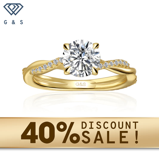 A 9ct yellow gold engagement ring with a flowing infinity design and a sparkling round brilliant moissanite.
