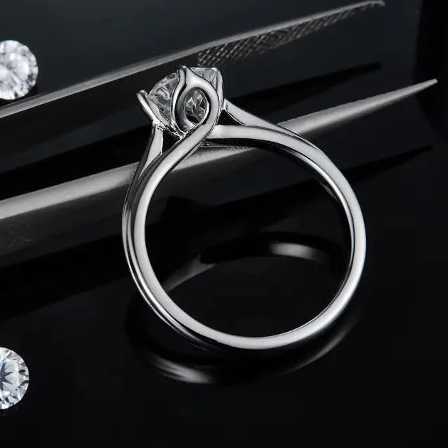 This engagement ring features a 1.00ct moissanite set within a feminine tulip design, crafted in sterling silver.