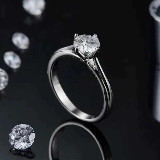 This ring features a 1.00ct moissanite showcased in a graceful tulip setting, crafted in bright sterling silver.
