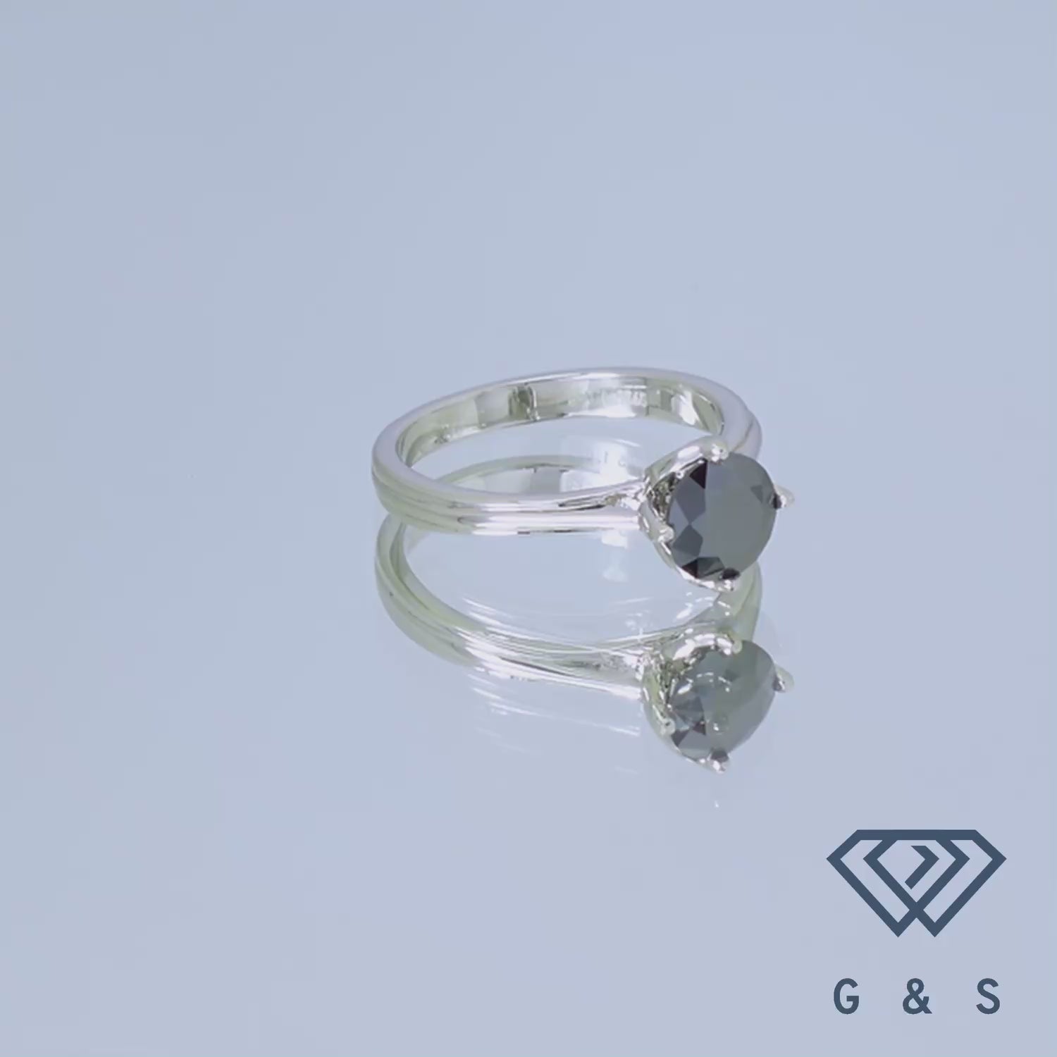 This sterling silver engagement ring features a striking 1.00ct black moissanite, cradled in a delicate tulip-inspired setting that highlights its dark beauty.