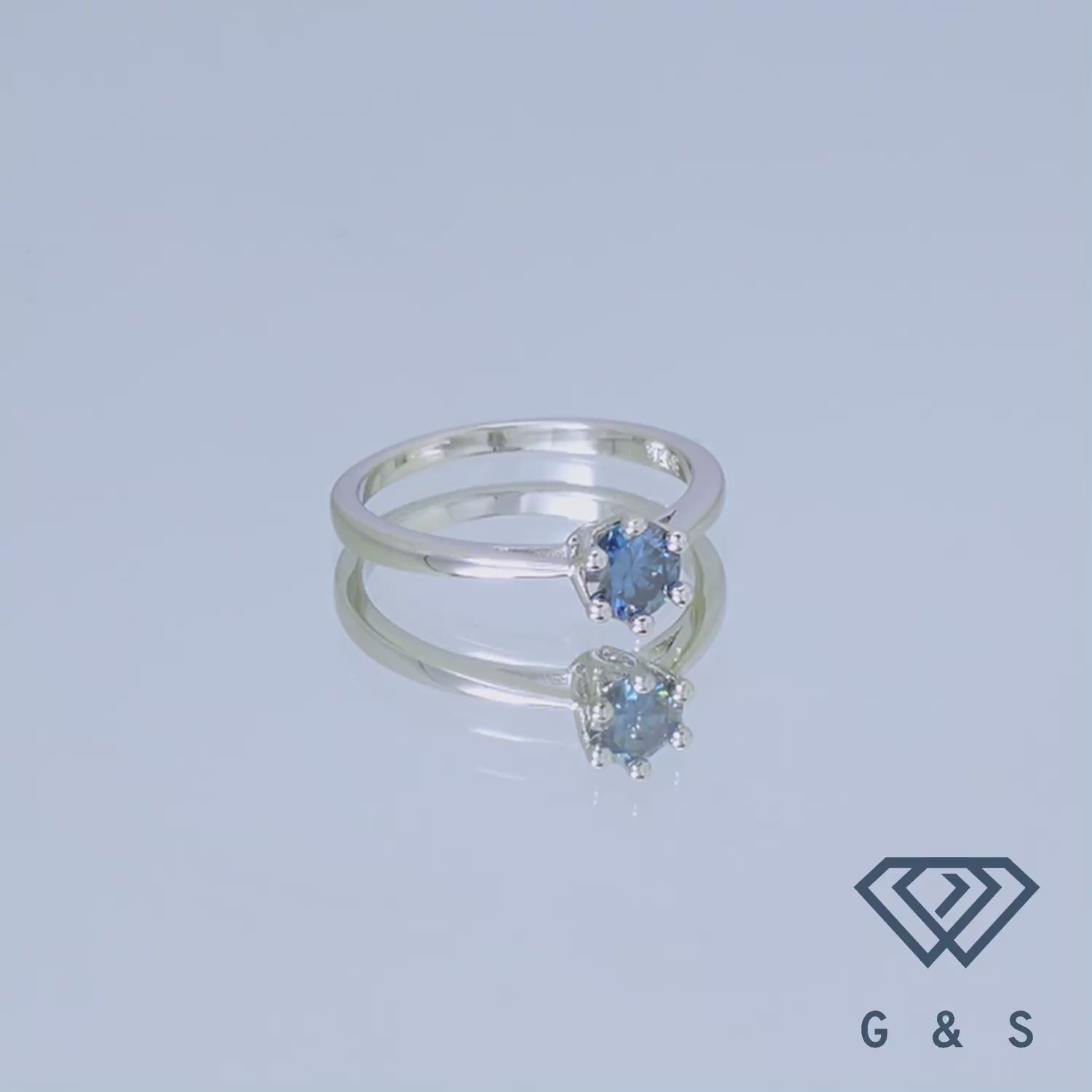 A classic solitaire ring with a 0.50ct blue moissanite, set in sterling silver with a beautiful floral basket detail.
