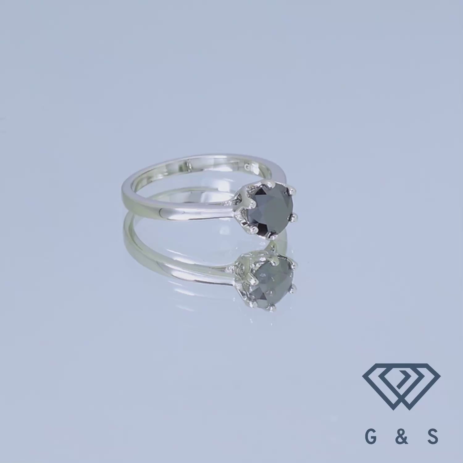 A striking 1.00ct black moissanite solitaire, held in a 6-prong floral basket setting, presented on a polished sterling silver band.