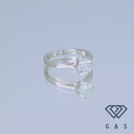 A detailed view of the tulip setting cradling a sparkling 1.00ct moissanite on a sterling silver band, highlighting the intricate floral design.