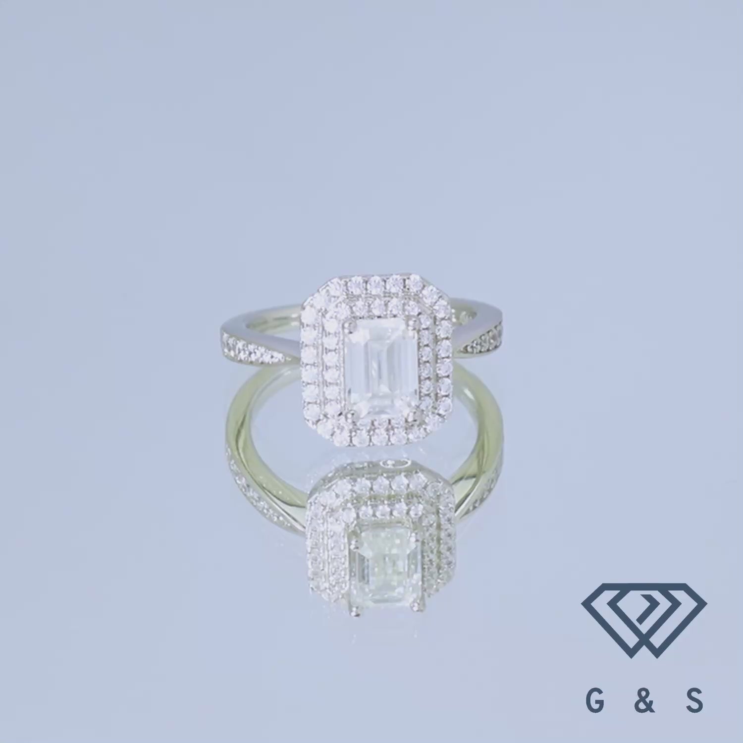 A sophisticated engagement ring featuring a 1.00ct emerald cut moissanite with a double halo for added brilliance.