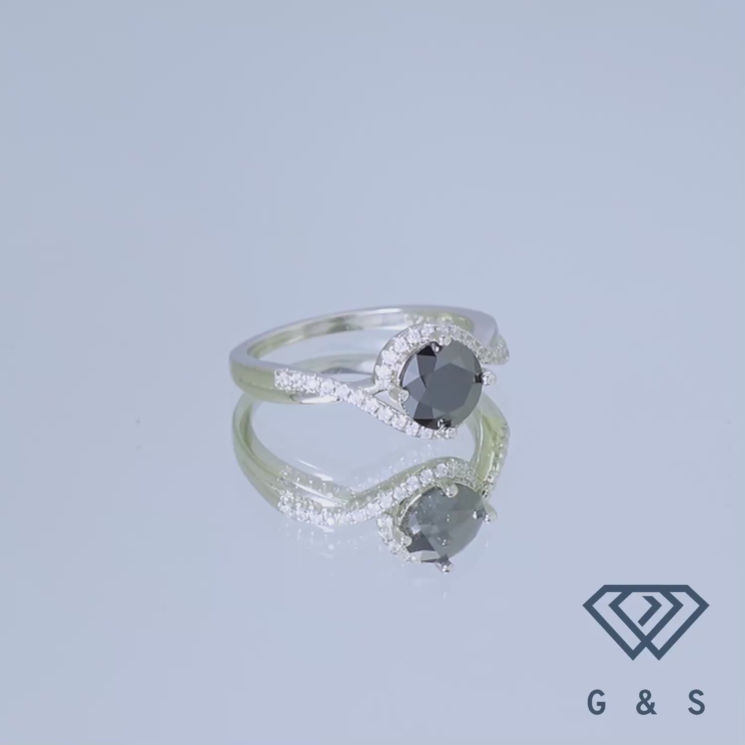 This elegant sterling silver ring features a captivating black moissanite with a dazzling halo, creating a unique and sophisticated look.