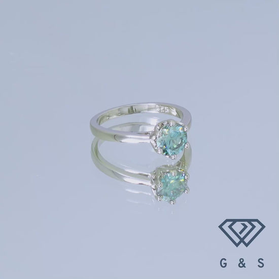 This elegant sterling silver ring features a 1.00ct green moissanite in a unique six-prong floral basket design.