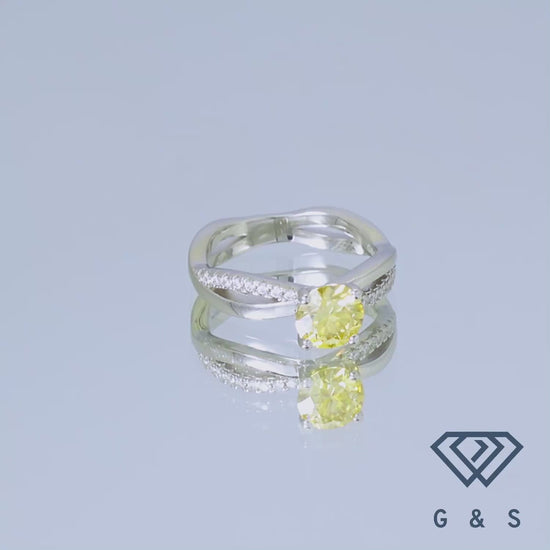 This elegant ring showcases a brilliant 1.00ct yellow moissanite, nestled within a flowing infinity motif, symbolizing eternal love, and crafted from high-quality sterling silver.