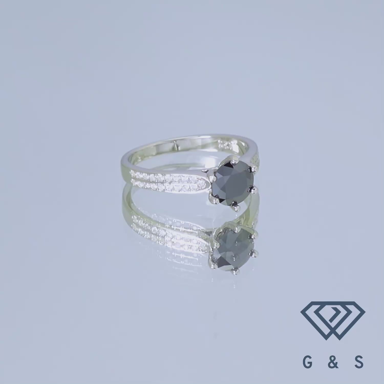This ring features a 1.00ct black moissanite with a pave halo, set in a polished sterling silver band.