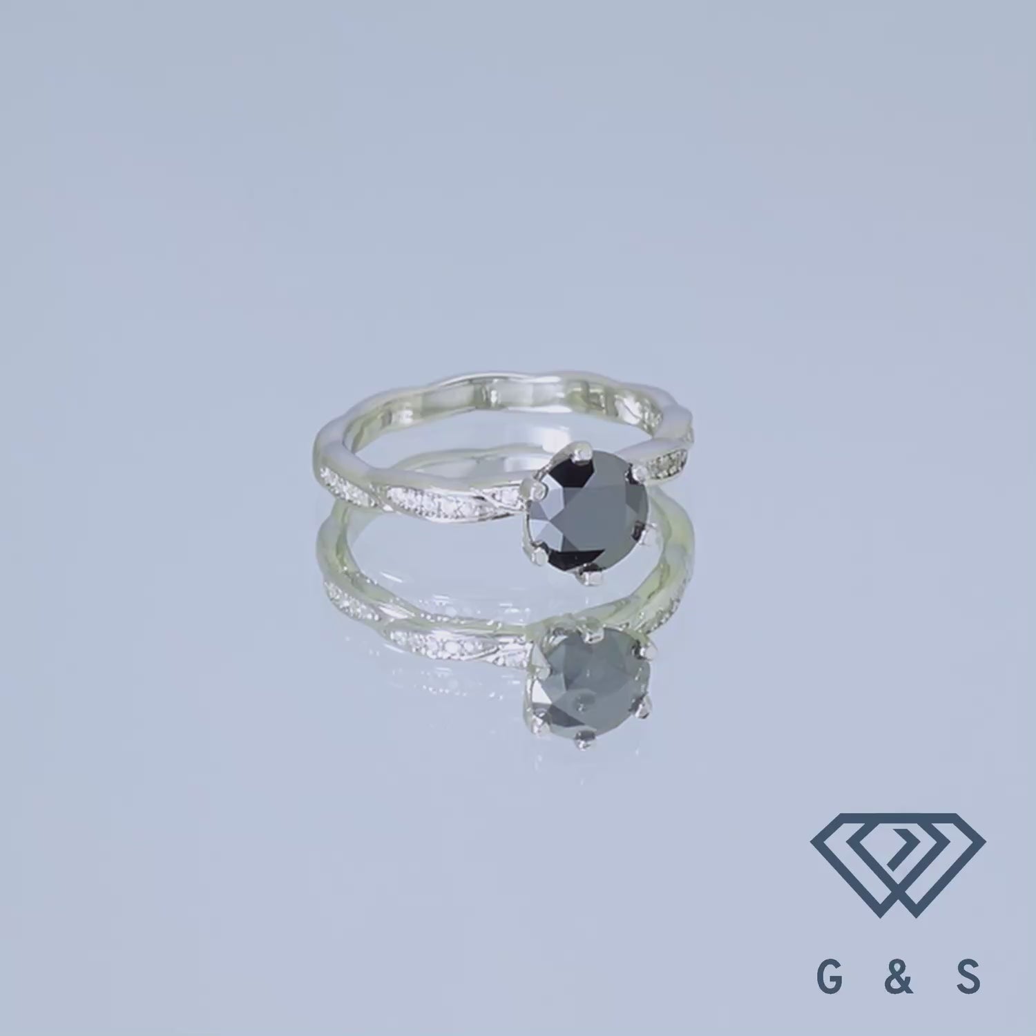 Showcasing a 1.00ct black moissanite, this ring has a classic, elegant vintage look with detailed designs on a sterling silver band.