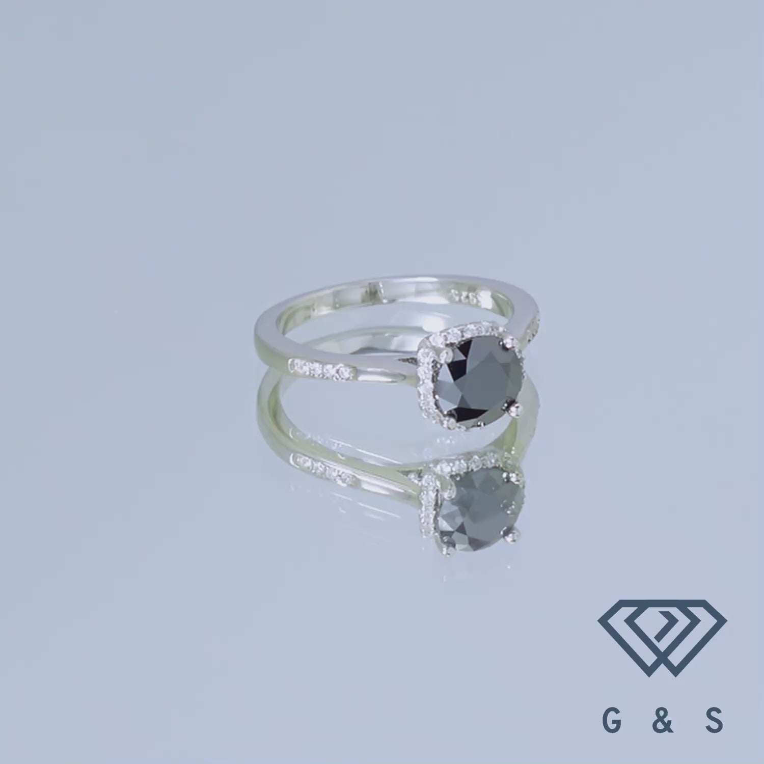 A contemporary sterling silver ring with a 1.00ct black moissanite and a modern halo design.