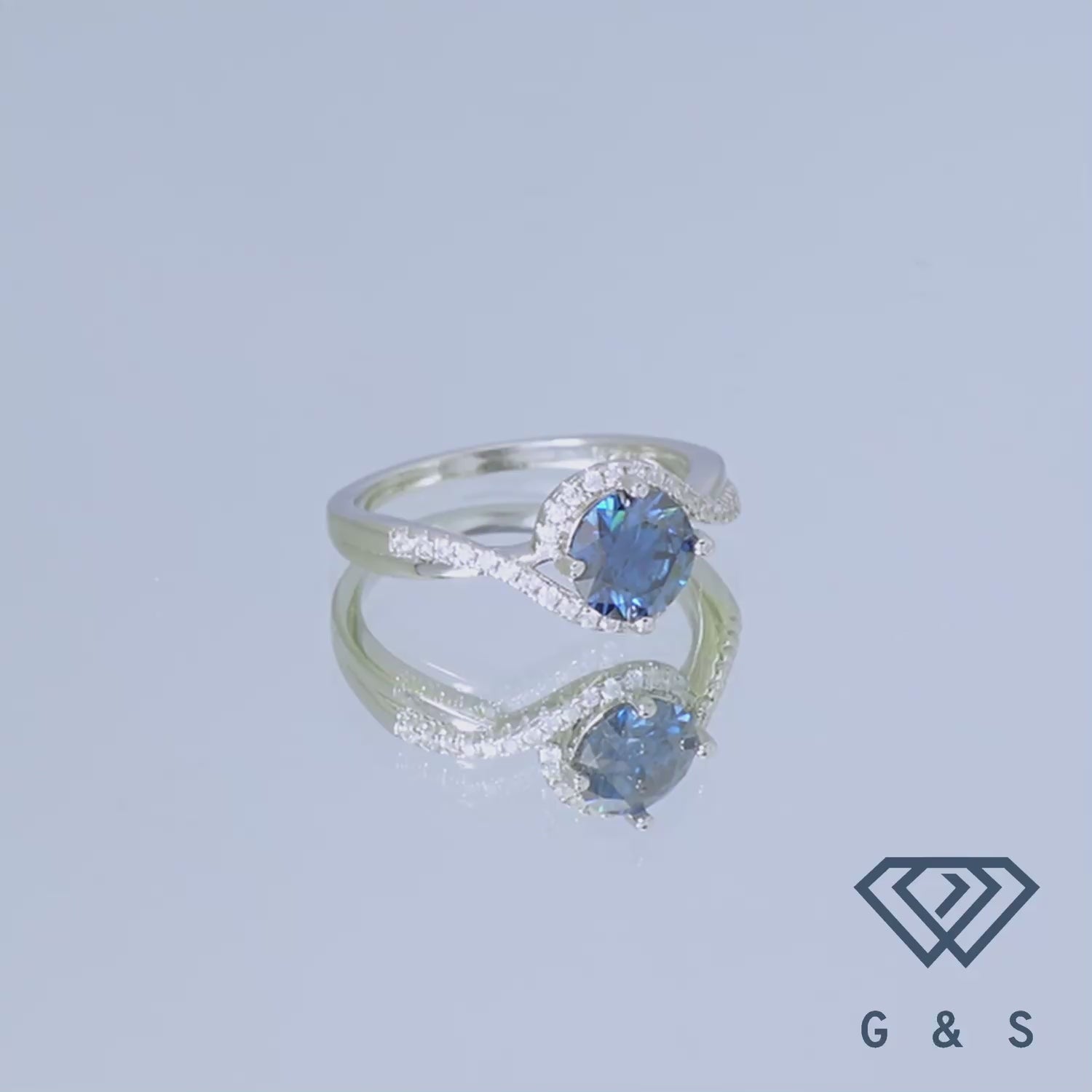 A stunning engagement ring with a 1.00ct blue moissanite and a dazzling halo, set in elegant sterling silver.