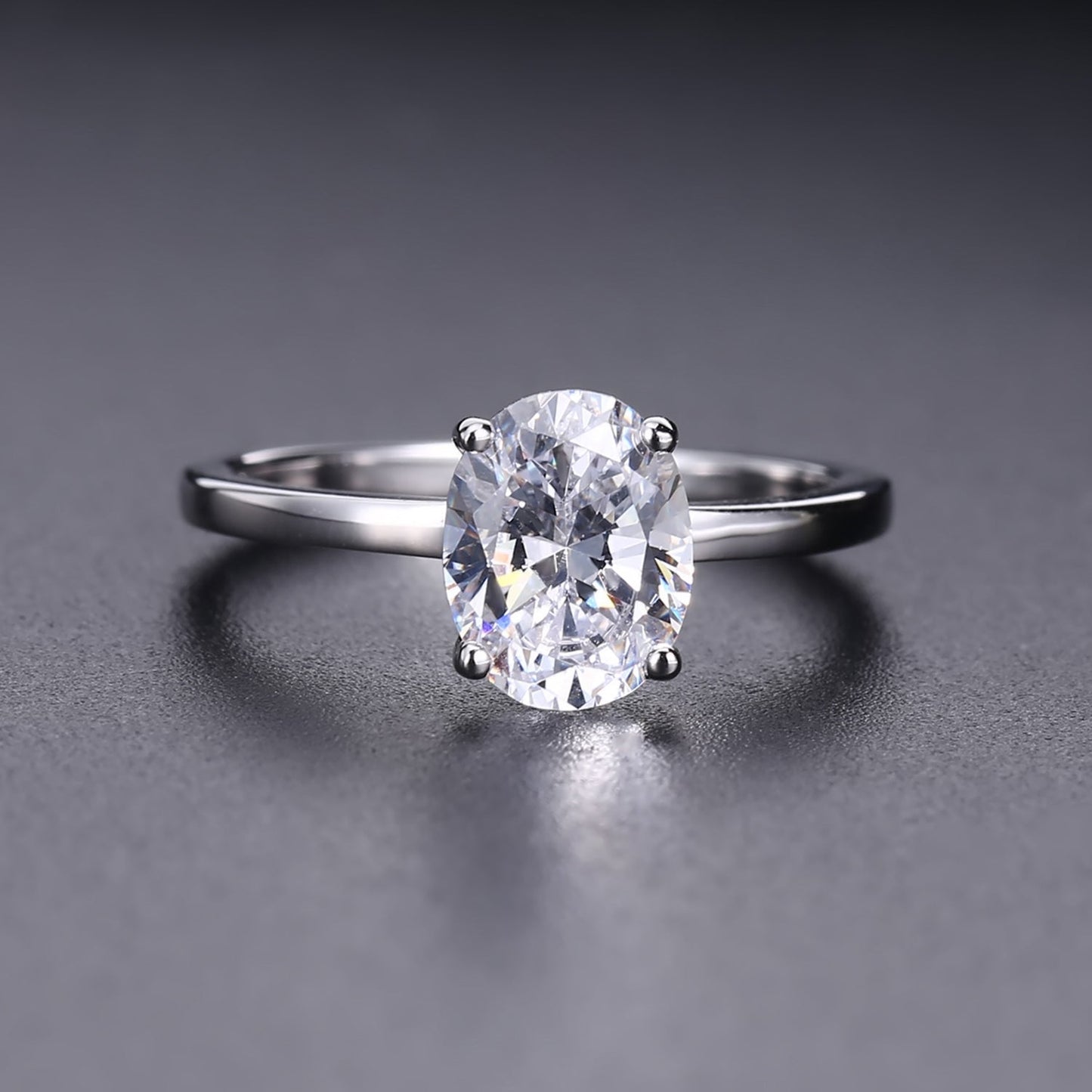 A stunning oval-cut moissanite takes center stage in this simple yet elegant 9ct white gold setting.